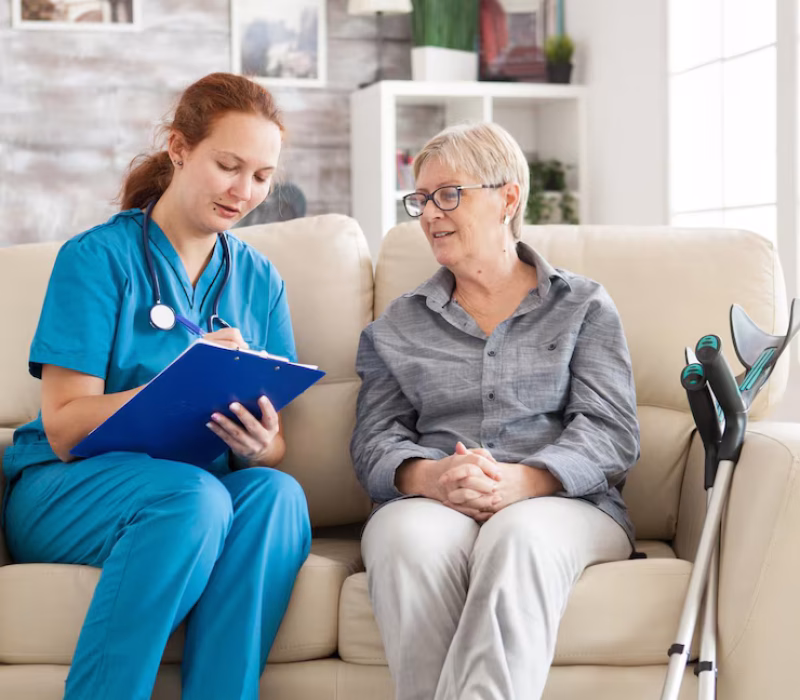 female-doctor-with-senior-woman-sitting-couch-nursing-home-writing-prescription-clipboard_482257-45168